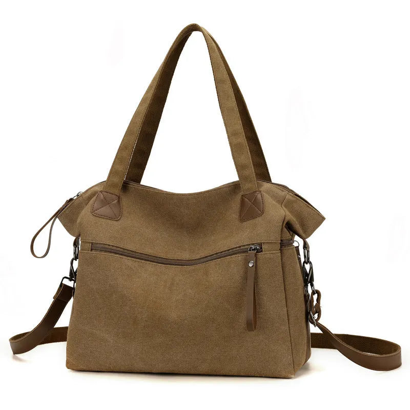 Large grey retro-style canvas shoulder bag with a horizontal square shape and multiple internal pockets.