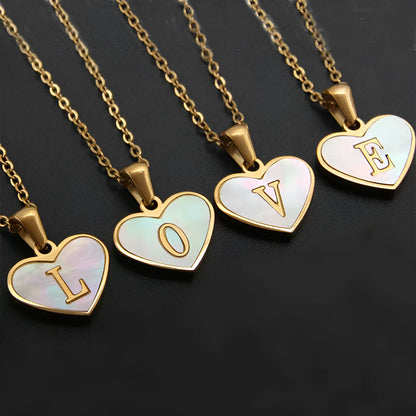 Gold-plated heart necklace with white shell pendant showing letter personalisation option