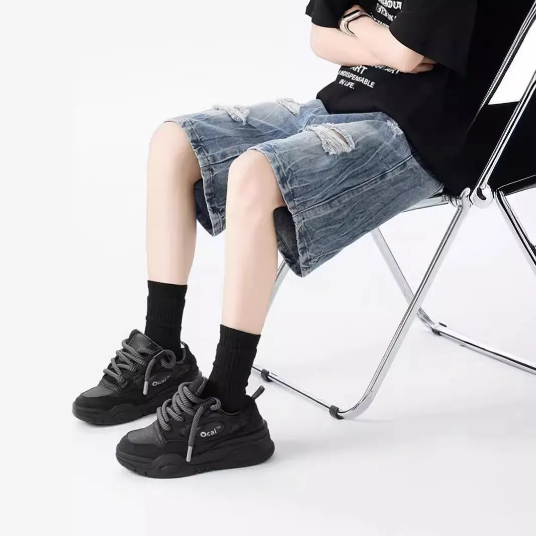 Mens loose fit ripped denim shorts in washed blue and black retro style