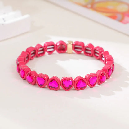 Colourful enamel heart shape on a silver-toned alloy stretch bracelet.