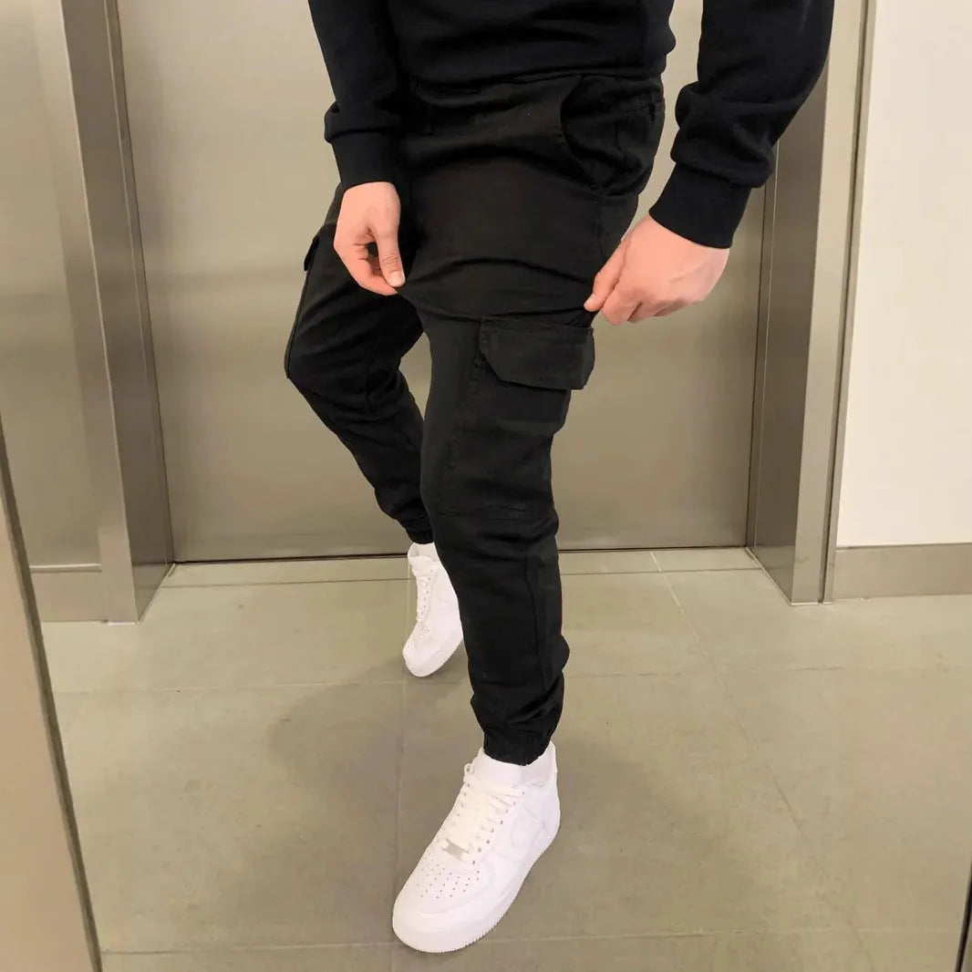 Men's light blue polyester loose-fit straight-leg trousers with dimensional patch pockets and elastic waistband laid flat.