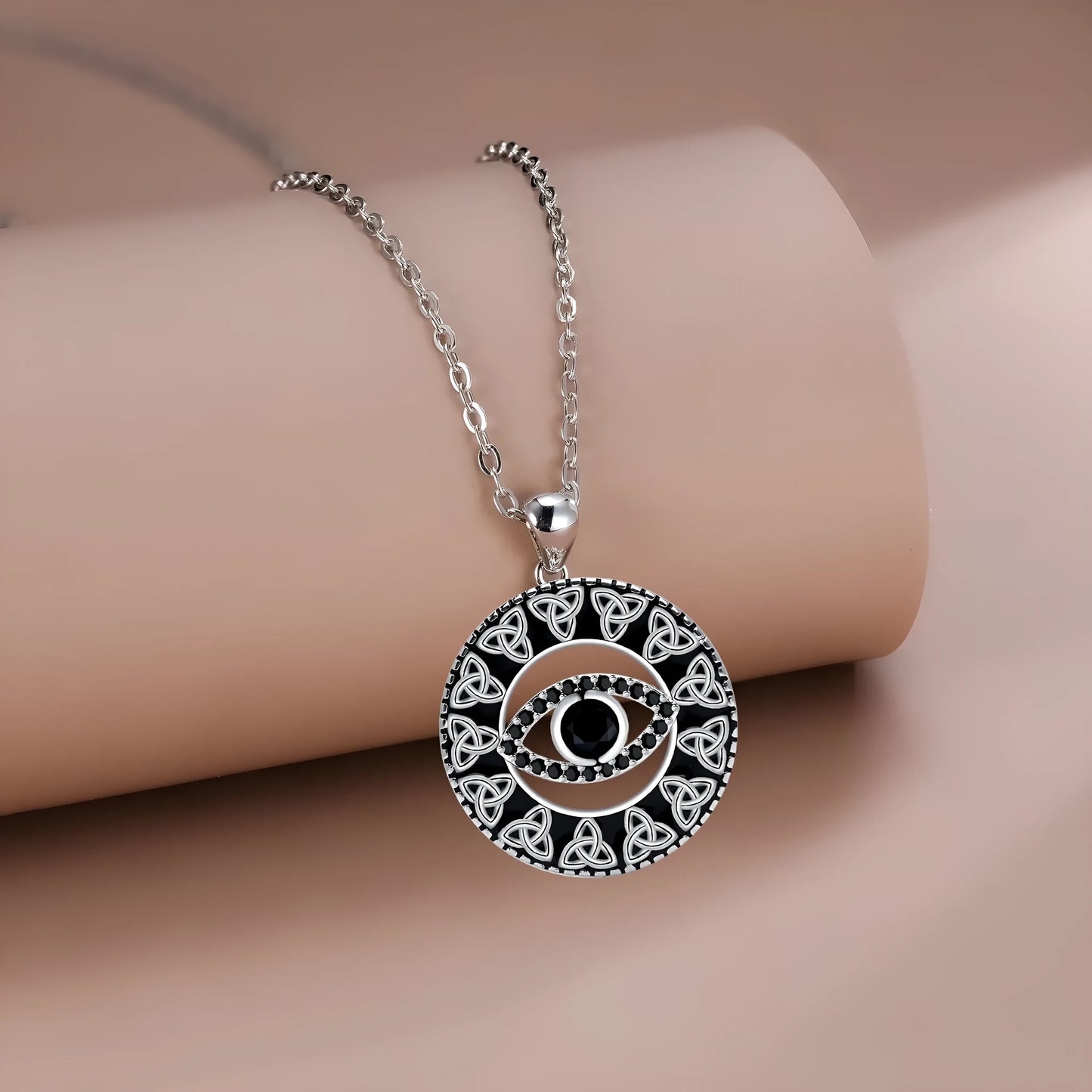 Close-up of a women's copper Devil's Eye pendant necklace on a cross chain, showing electroplated finish.