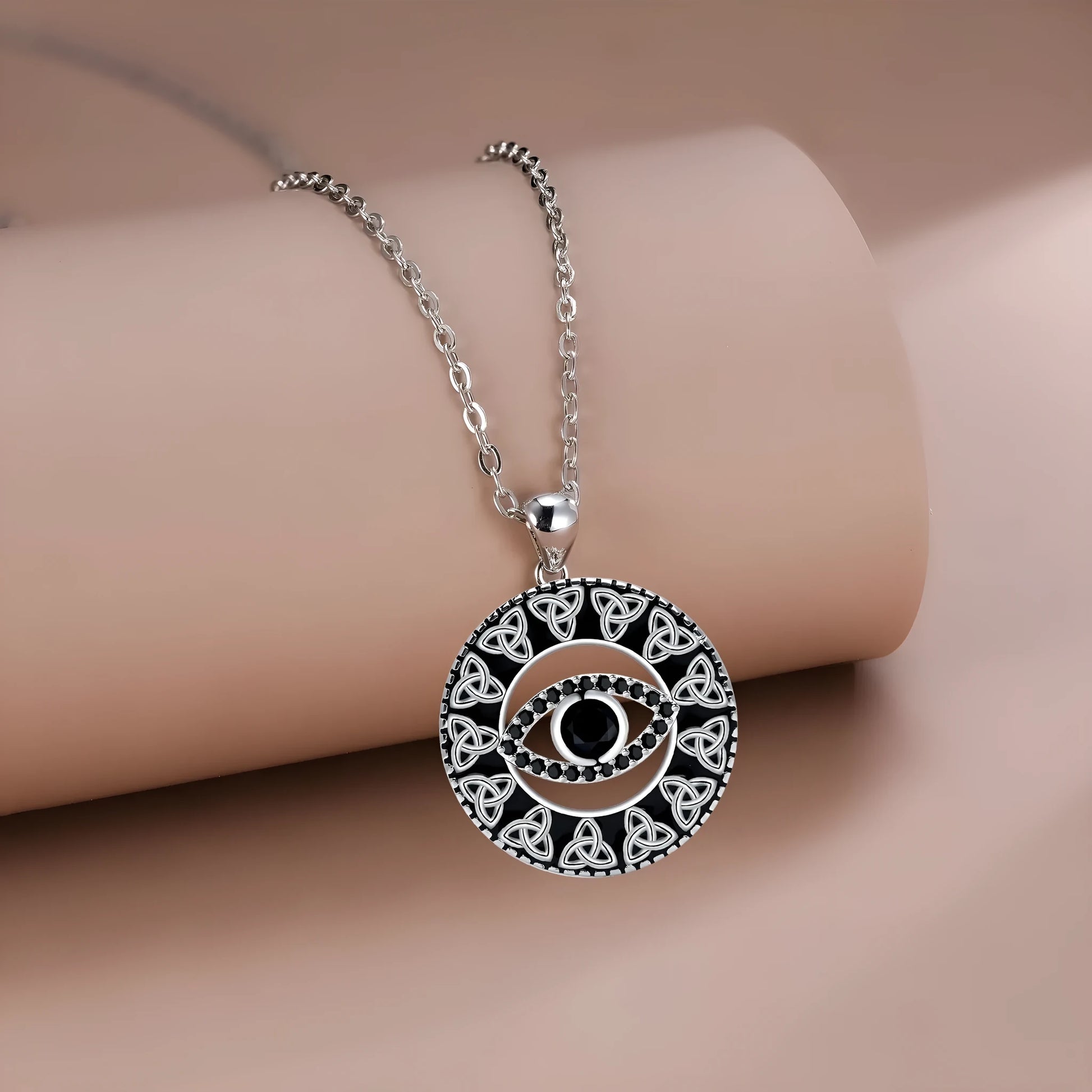 Close-up of a women's copper Devil's Eye pendant necklace on a cross chain, showing electroplated finish.