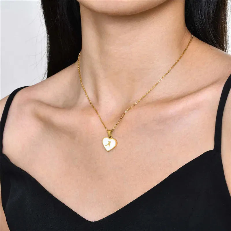Gold-plated heart necklace with white shell pendant showing letter personalisation option