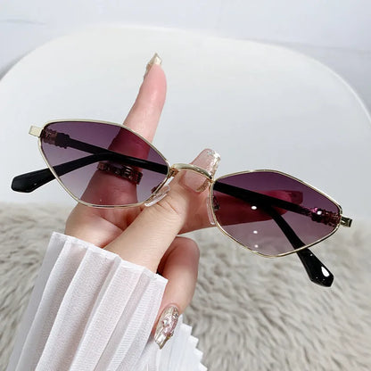 Gold metal frame rhombus-shaped cat eye sunglasses on a neutral background.