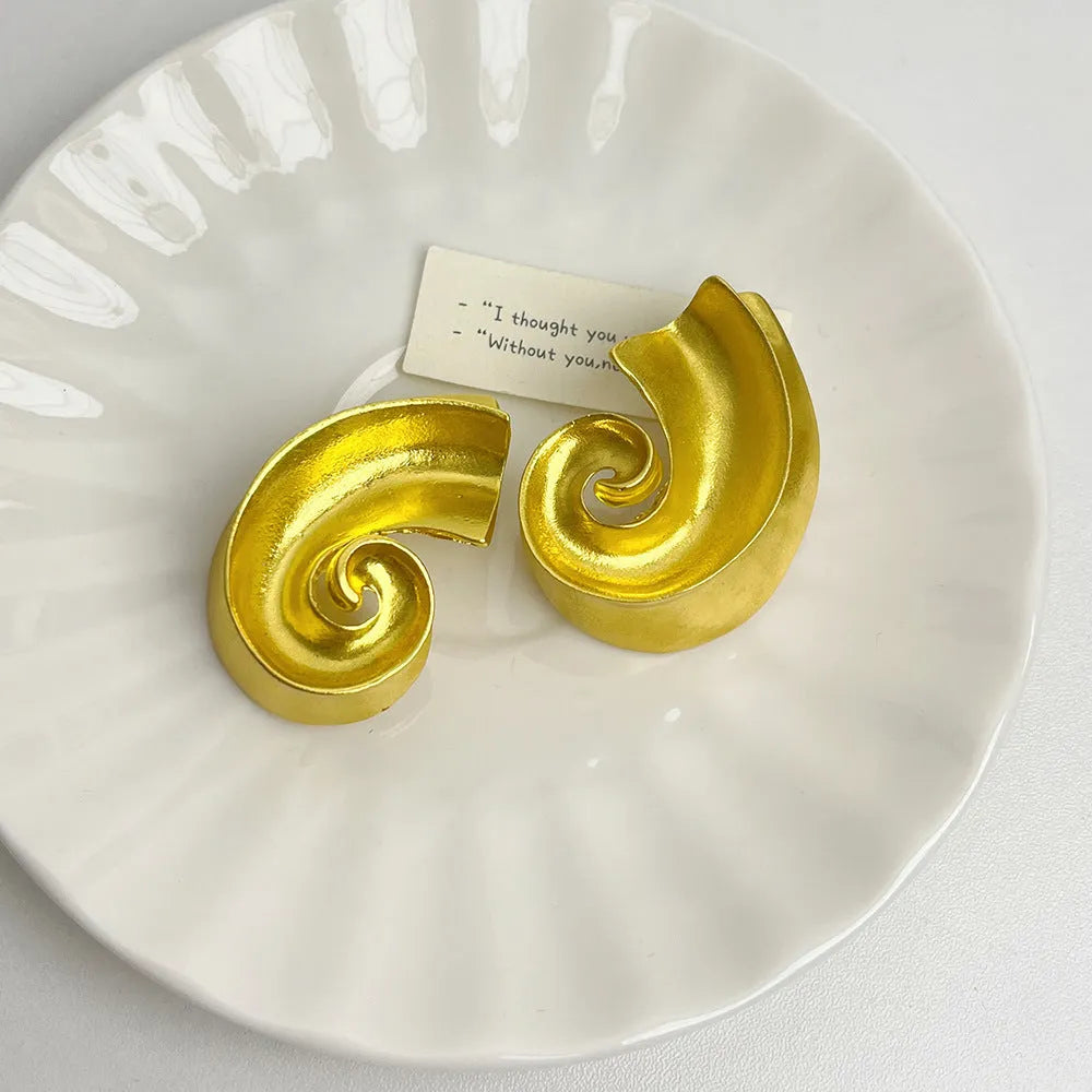 Gold and silver retro geometric alloy ear studs on a white background.