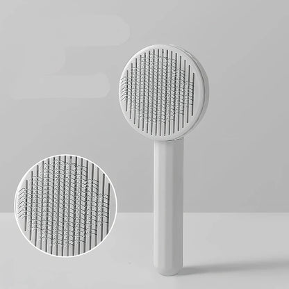 Self-cleaning cat comb with floating needle teeth and built-in hair storage chamber in assorted colours