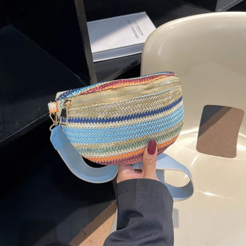Blue and pink woven straw beach bag with single shoulder strap and zipper compartment