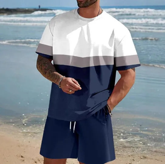 Man wearing a loose fit grey short-sleeved t-shirt and matching shorts from a summer leisure suit.
