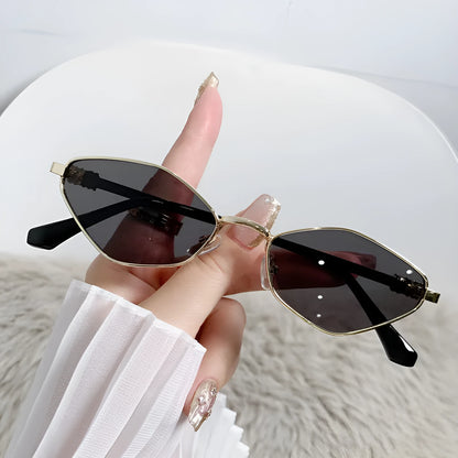 Gold metal frame rhombus-shaped cat eye sunglasses on a neutral background.