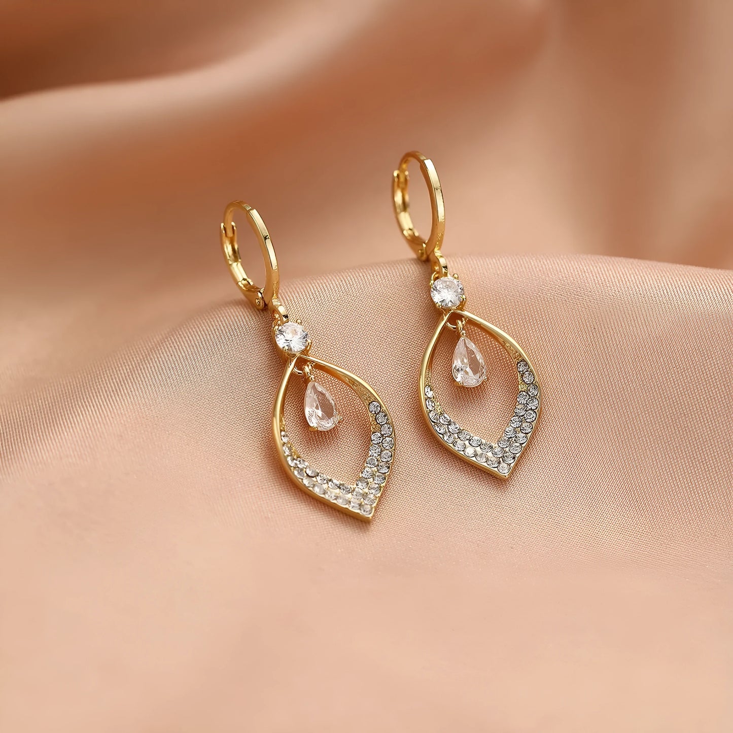 Women's copper teardrop tassel earrings with zircon detail and choice of gold or silver buckle.