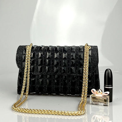 Silver rhinestone-decorated PU leather clutch bag with a metal chain strap, shown open to reveal interior phone pocket.