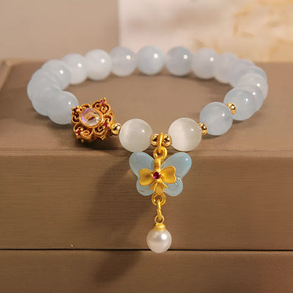 Women's crystal bracelet with a blue aquamarine butterfly pendant and rhinestone details.