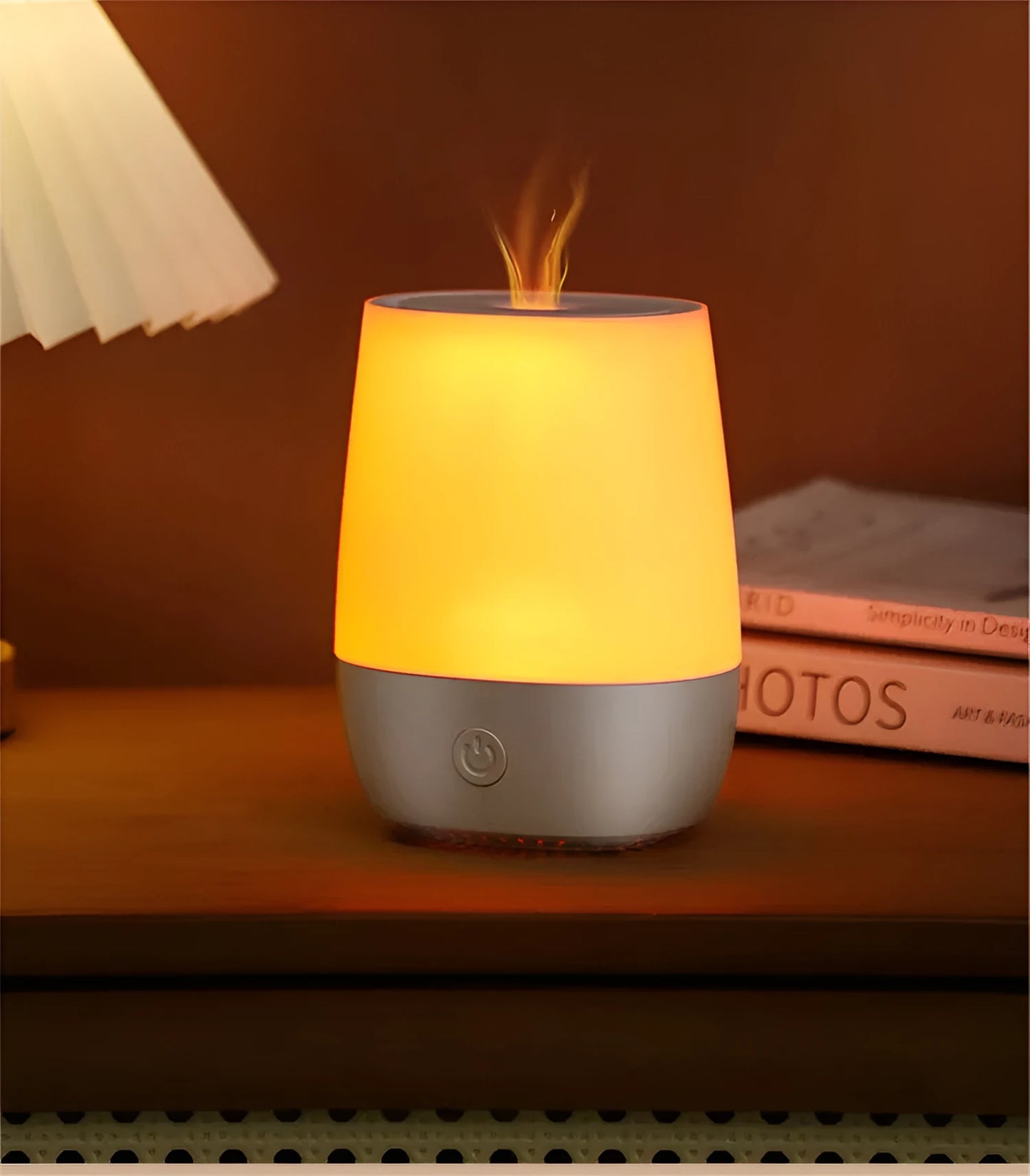 White USB aroma diffuser with simulated flame lighting effect on a wooden surface.