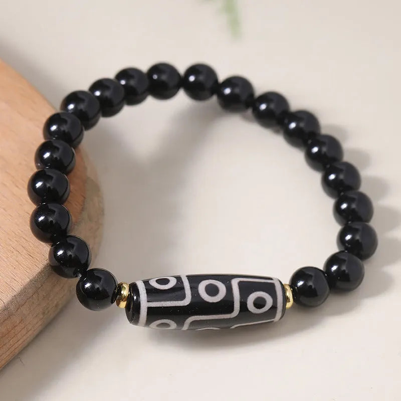 Obsidian-coloured agate Tibet dzi bead bracelet with traditional ethnic design