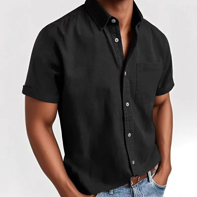 Man wearing a grey loose-fit short sleeve cardigan style shirt