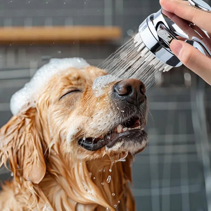 Silver dog shower attachment with integrated silicone comb and rubber grip handles.