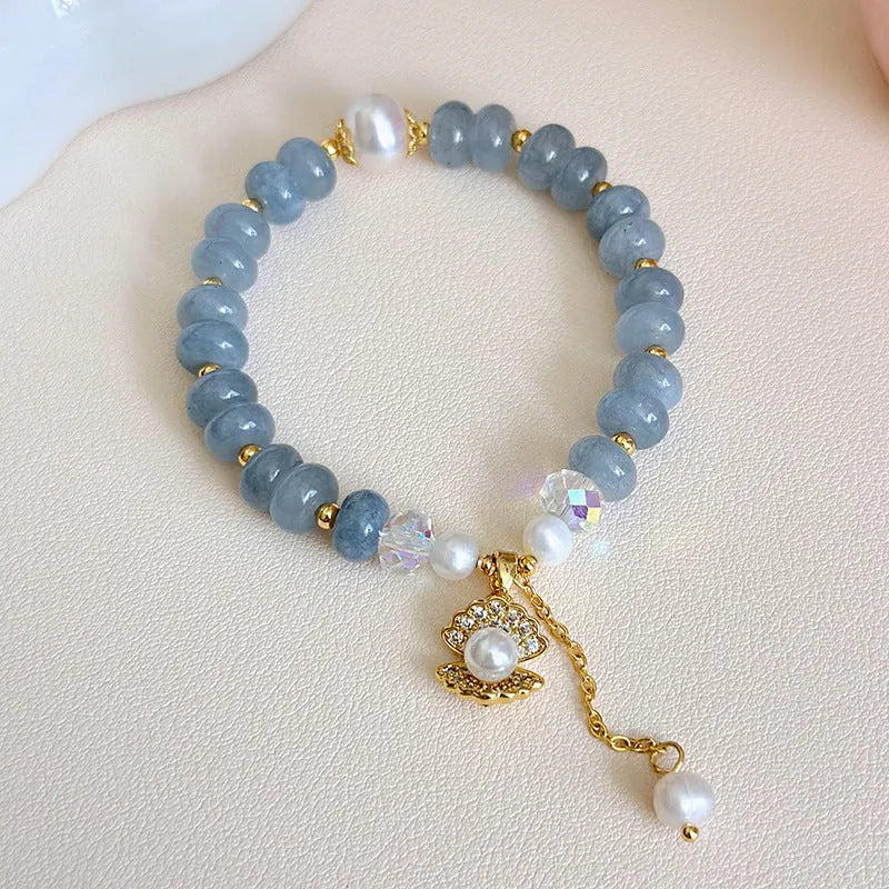 Natural aquamarine pearl bracelet with abalone shell charms on adjustable cord