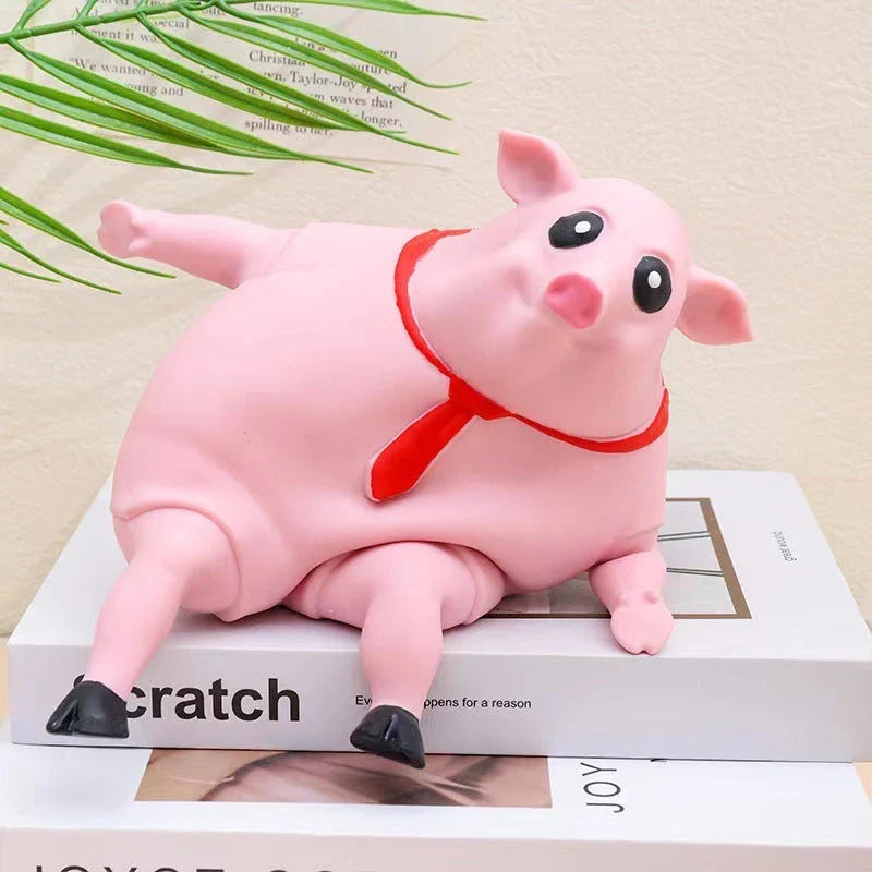 Adorable piggy-shaped stress relief toy made of eco-friendly rubber with a charming red scarf design