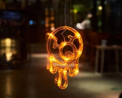 Spooky Halloween window lights featuring ghostly silhouettes, carved pumpkins, and creepy spiders for festive seasonal decor