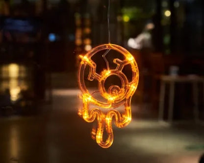 Halloween window hanging LED lights set with spider, pumpkin, and ghost designs for battery-powered holiday decorations