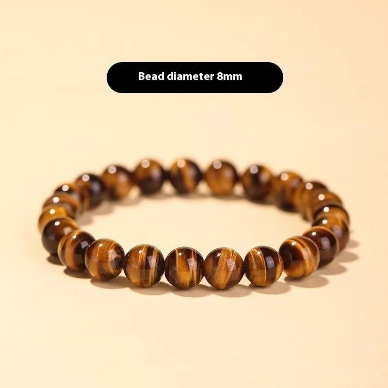 Tigereye dzi bead buddha bracelet with adjustable closure, shown in simple bracelet style.