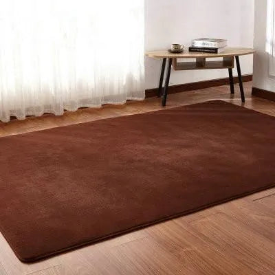 Solid colour plush rectangle area rug with soft texture on a wooden floor.
