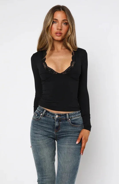 Women's slim fit black pullover top with long sleeves and decorative lace floral design.