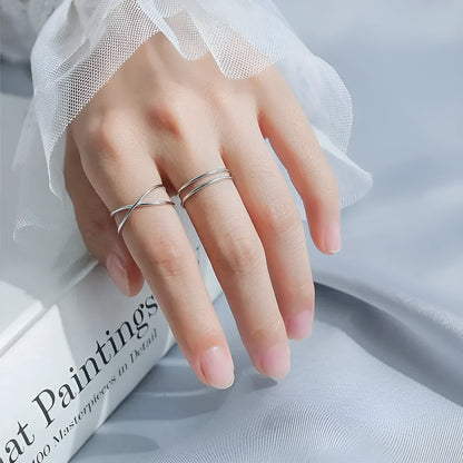 Silver plated geometric cross ring for women with adjustable opening on a white background