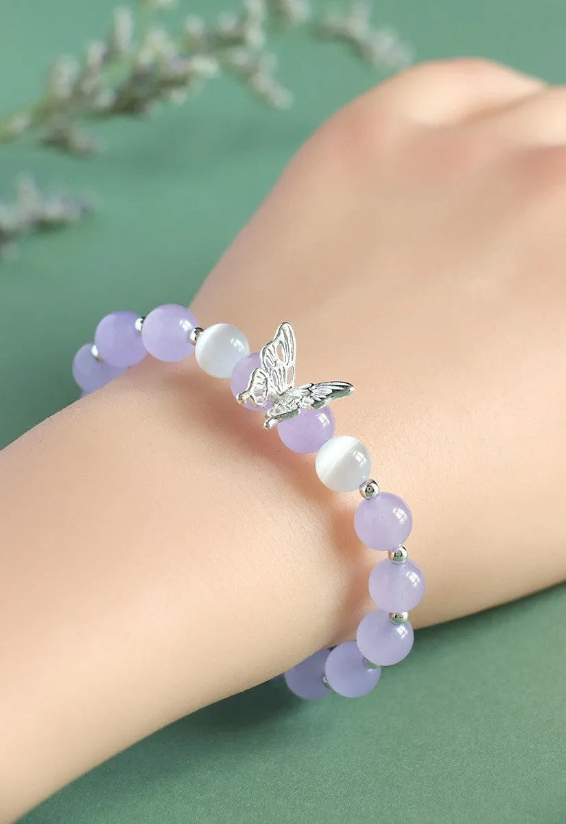 Women's crystal bow bracelet with butterfly design in ocean blue, pink, and purple colour options