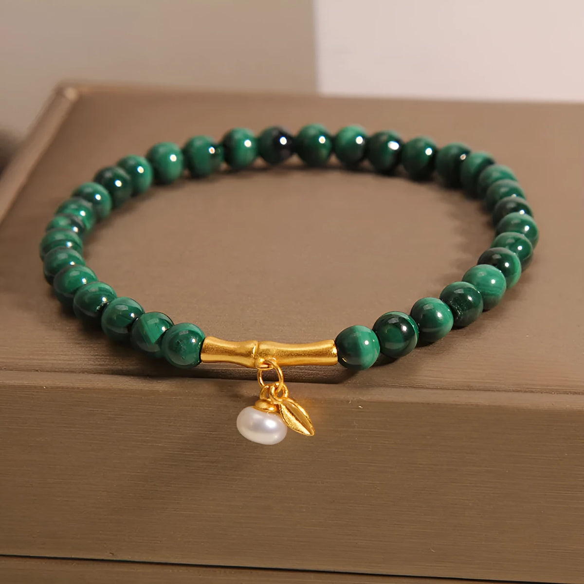Close-up of a women's adjustable white crystal bracelet featuring a high-rise lucky bamboo design on a wrist.
