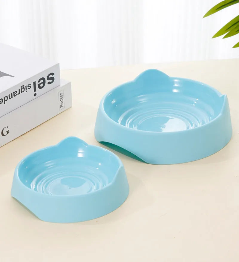 Blue ceramic dog slow feeder bowl with raised internal maze pattern for large breed dogs on a wooden floor.