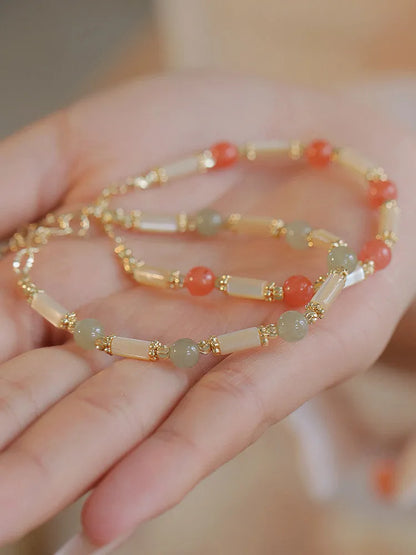 Women's Hetian jade bracelet with bamboo joint design on a white background.