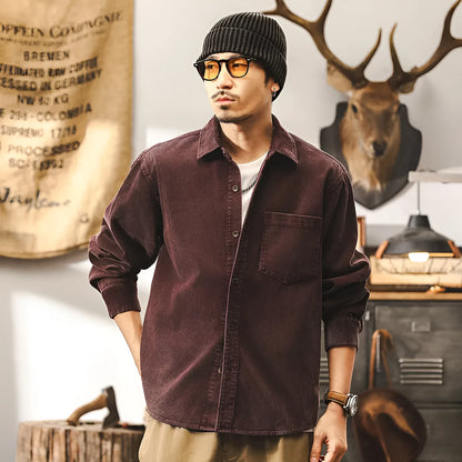 Men's red corduroy loose-fit shirt jacket with long sleeves, showing front view.