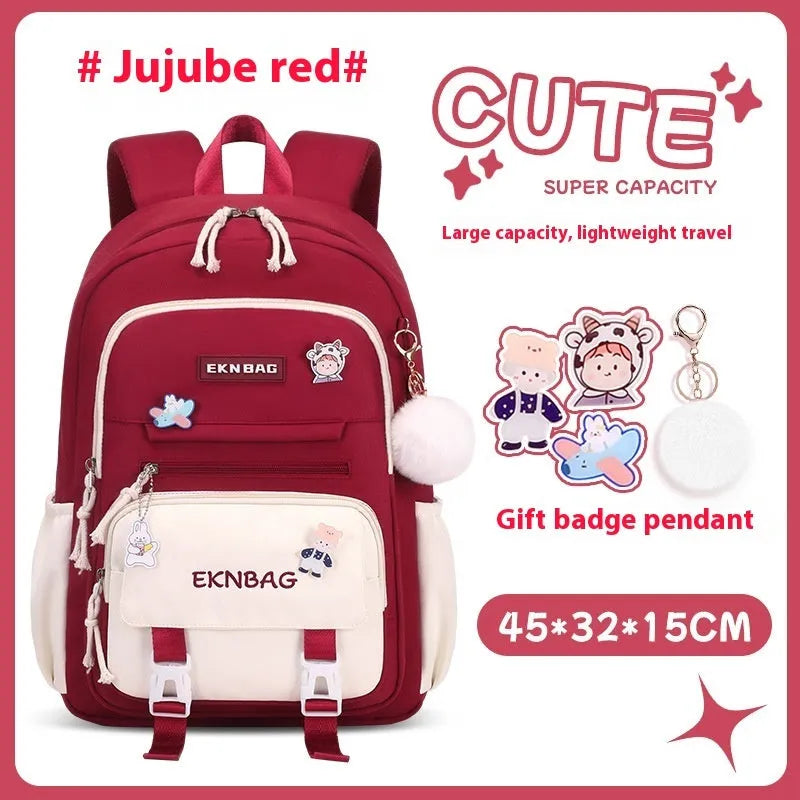Pink girls school backpack with curved shoulder straps on a wooden floor