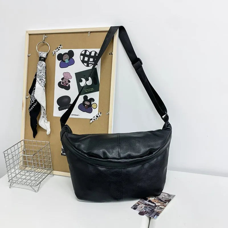 Men's brown vintage PU leather crossbody bag showing large main compartment and slim profile
