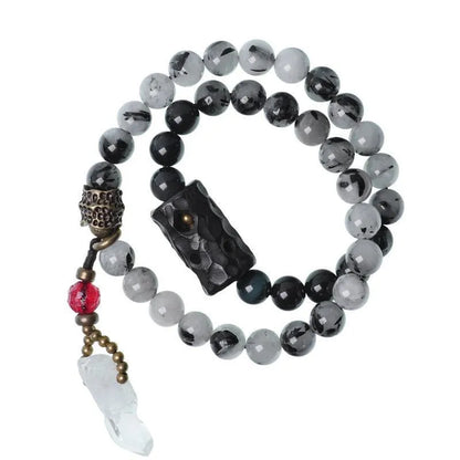 Ethnic black hair crystal bracelet with white tassel showing bending and lacing construction