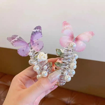 Colourful butterfly and pearl elastic hair band for children on a white background.