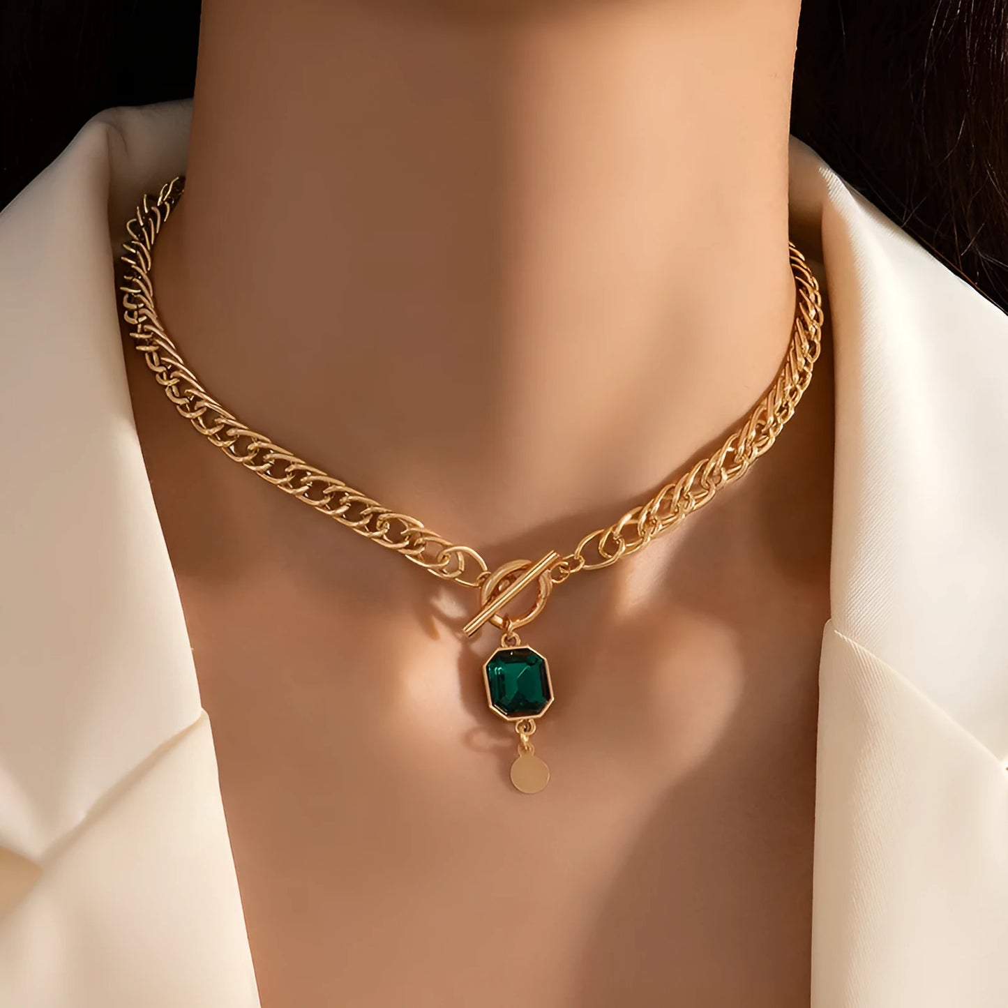Gold geometric round pendant on a titanium steel Cuban link necklace, 50cm long.