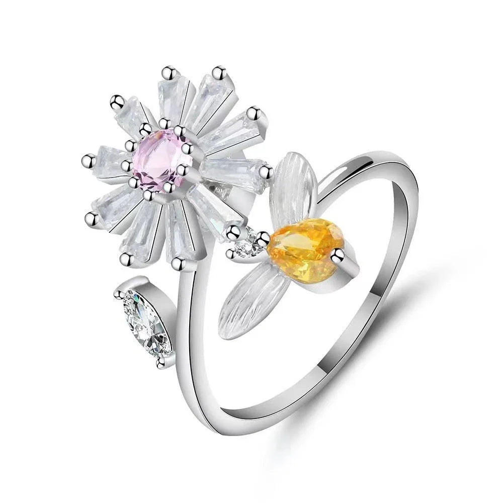 Adjustable spinner ring with rotating floral, geometric, and nature-inspired motifs for women's fashion and stress relief