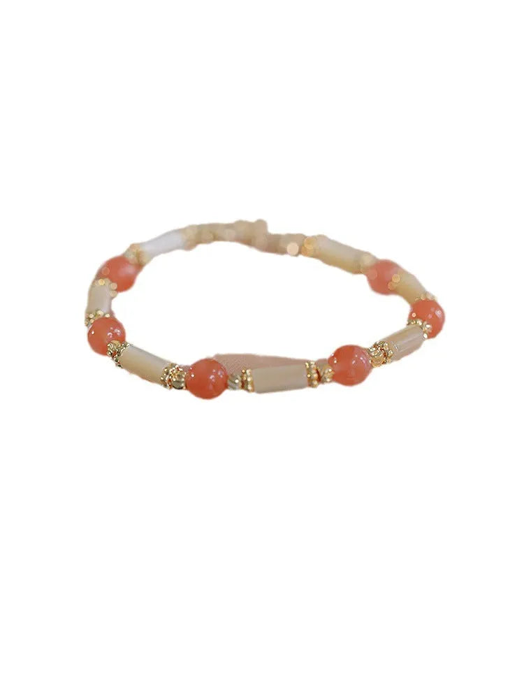 Women's Hetian jade bracelet with bamboo joint design on a white background.