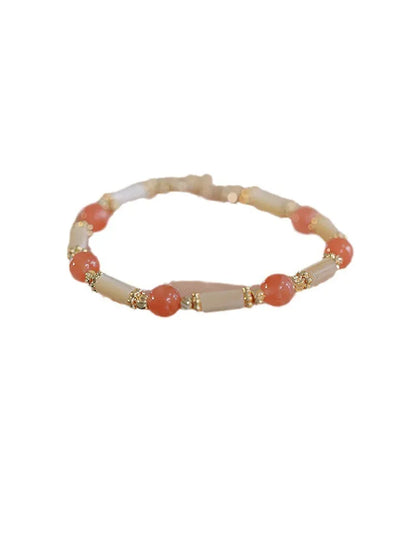 Women's Hetian jade bracelet with bamboo joint design on a white background.