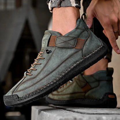 Men's black mid-top Martin boots with elastic band and sewn sole on a plain background.