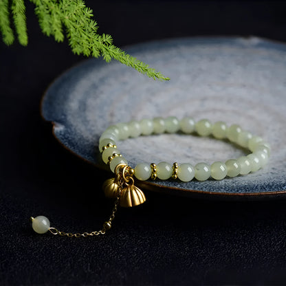 Natural Hetian jade bracelet with 6mm beads, engraved fu character, and constellation design on a simple string.