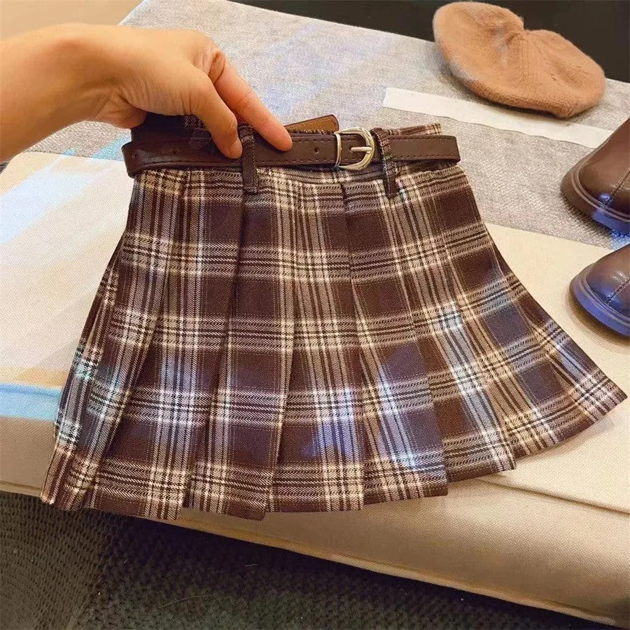 Girls' plaid pleated A-line skirt in cotton blend fabric, shown on a hanger.