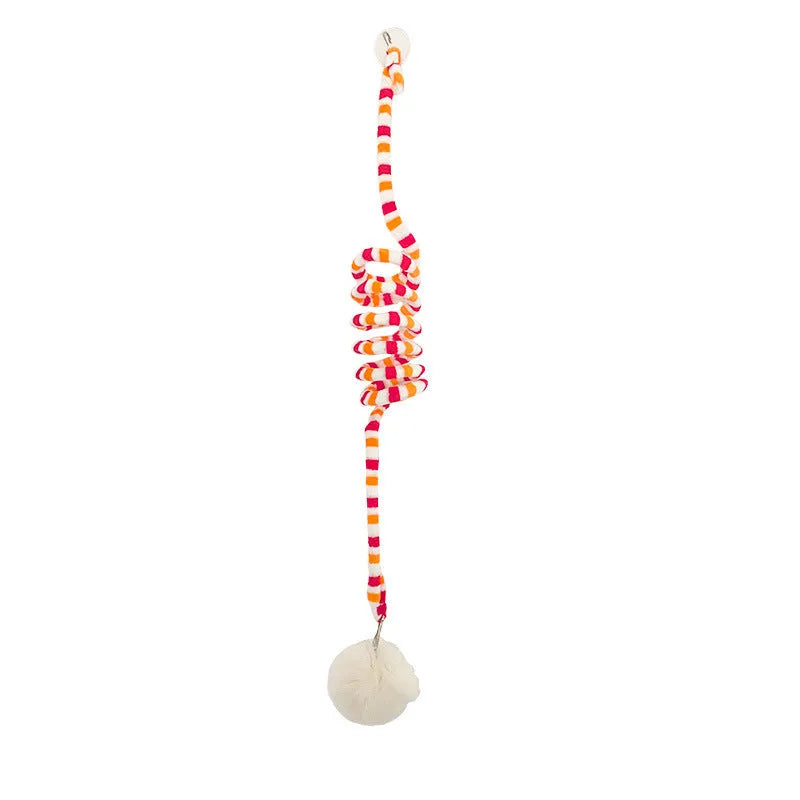 Hanging cat toy with spring, bell, and inflatable ball attached to a door via a suction cup.