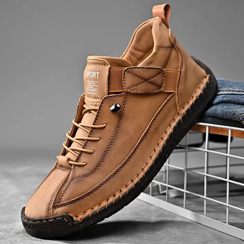 Men's black mid-top Martin boots with elastic band and sewn sole on a plain background.