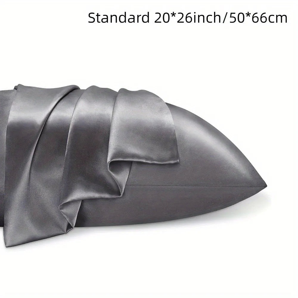 Pair of solid colour satin pillowcases showing smooth plain weave texture and reactive dye colour