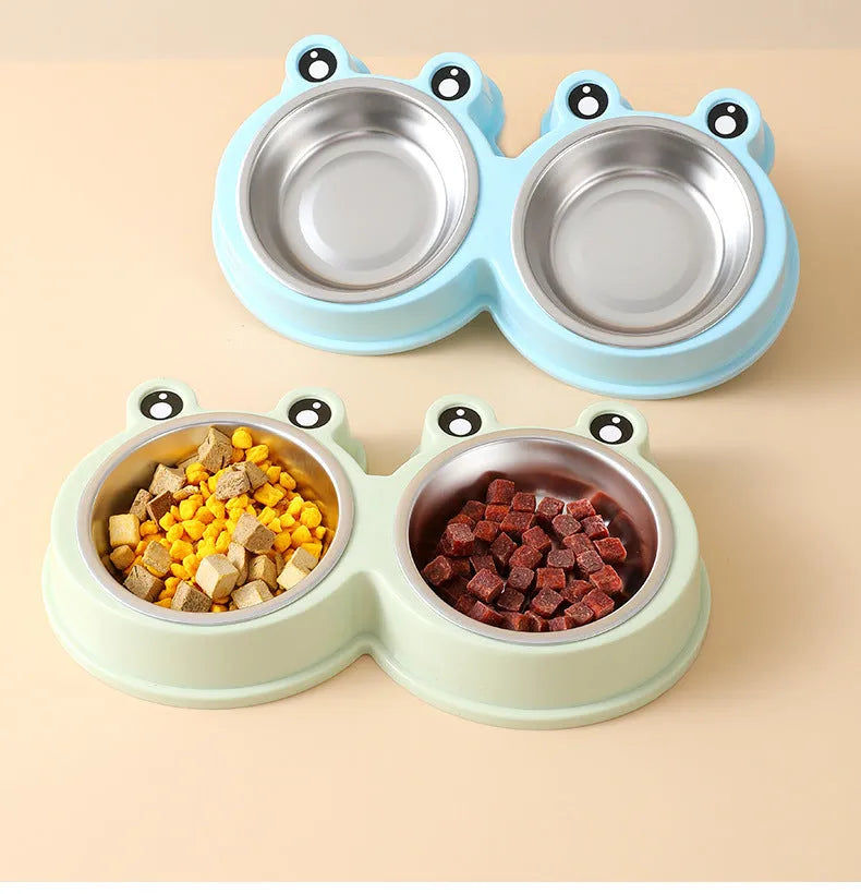 Stainless steel pet bowl with frog design and two compartments for food and water.