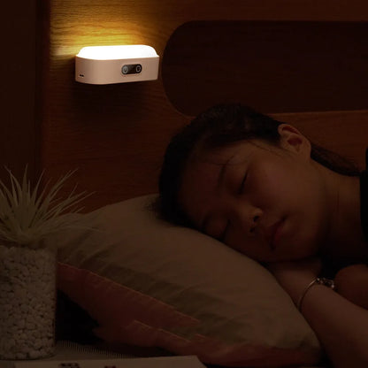 White magnetic USB rechargeable LED night light with touch controls, shown attached to a metal surface.